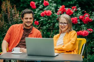 man and woman sitting together at outdoor table