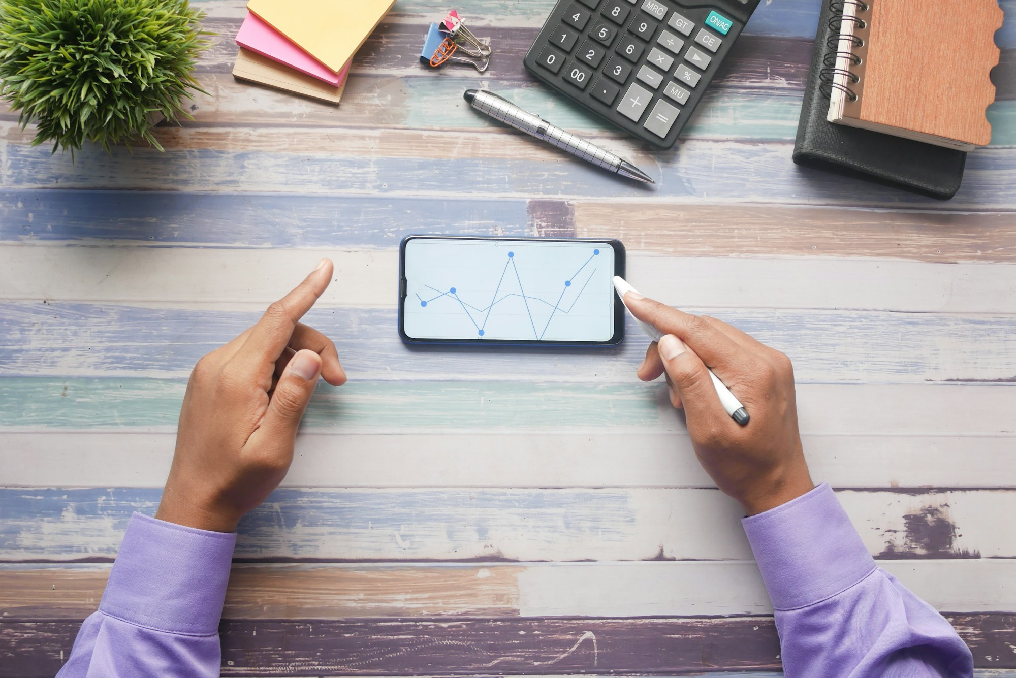 young man analyzing stock chart on smart phone